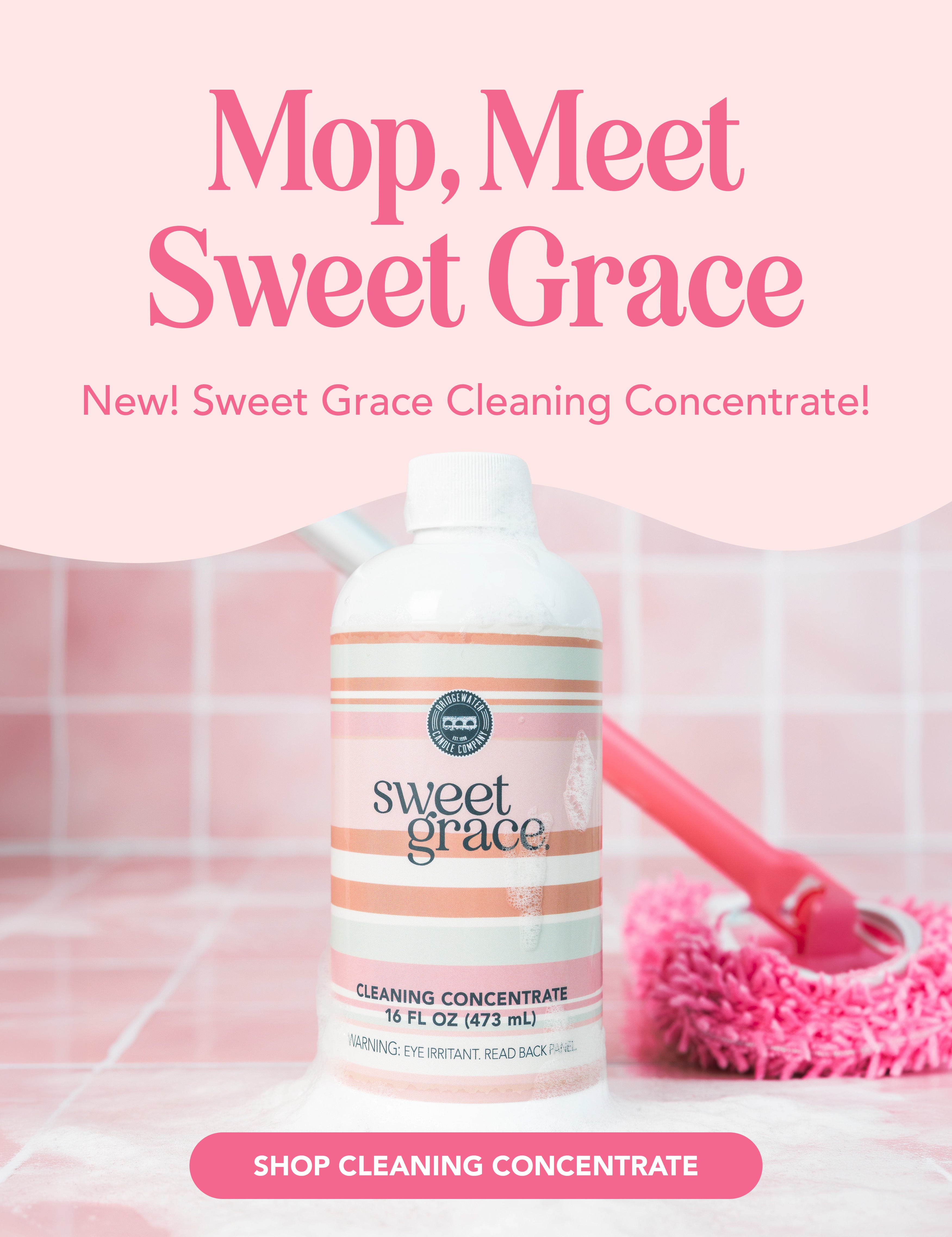 A bottle of Sweet Grace Cleaning Concentrate sits on pink tiles with a pink mop and bucket in the background. Pink text above reads, Mop, Meet Sweet Grace..