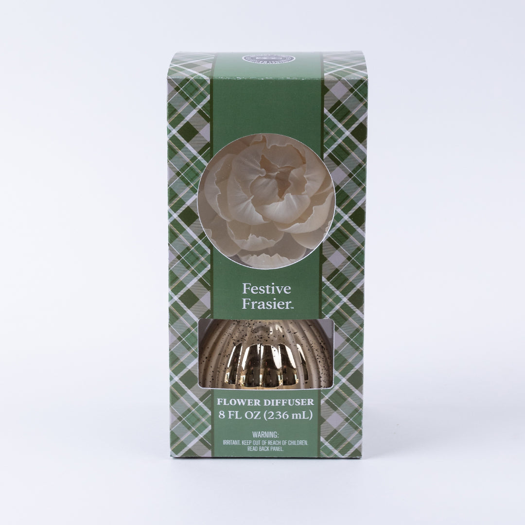 The Bridgewater Candle Company Festive Frasier Holiday Mercury Flower Diffuser (8 fl oz/236 mL) features a green plaid box with a window showing a white flower—ideal for bringing festive holiday decor to your space.