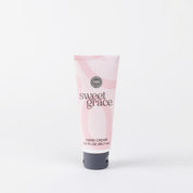 A 3.0 fl oz (88.7 mL) pink tube of Bridgewater Candle Company’s Sweet Grace Hand Cream stands upright against a white background, displaying black and white text with a swirl design that highlights its fragrant, elegant appeal.