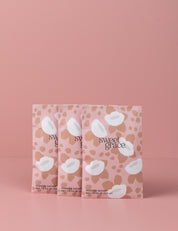 Three Sweet Grace Modern Flower Sachets by Bridgewater Candle Company, featuring pink and beige floral patterns, stand upright against a matching background—adding the beloved Sweet Grace fragrance to your home collection.