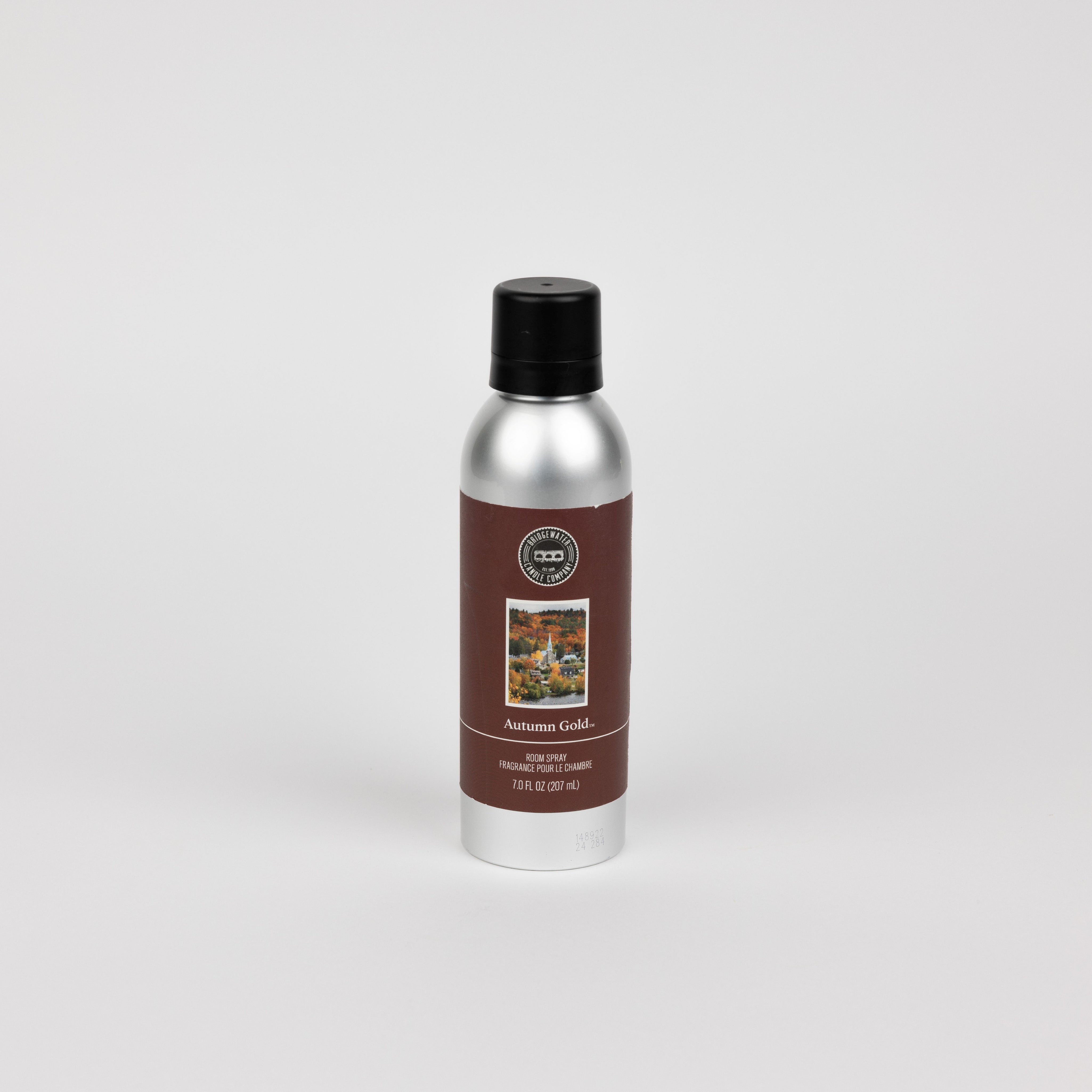 A silver can with a black cap and brown label reading Autumn Gold by Bridgewater Candle displays autumn foliage and states 12 oz. (340 g) home fragrance room spray, shown against a plain white background.