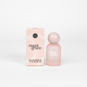 Sweet Grace eau de parfum bottle and packaging box sitting on a white background