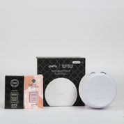 The PURA + Bridgewater Smart Home Diffuser Set with Sweet Grace and Afternoon Retreat V5 by Bridgewater Candle features a round white PURA diffuser, sleek black packaging, and fragrance boxes for Sweet Grace and Afternoon Retreat, all displayed on a white background.