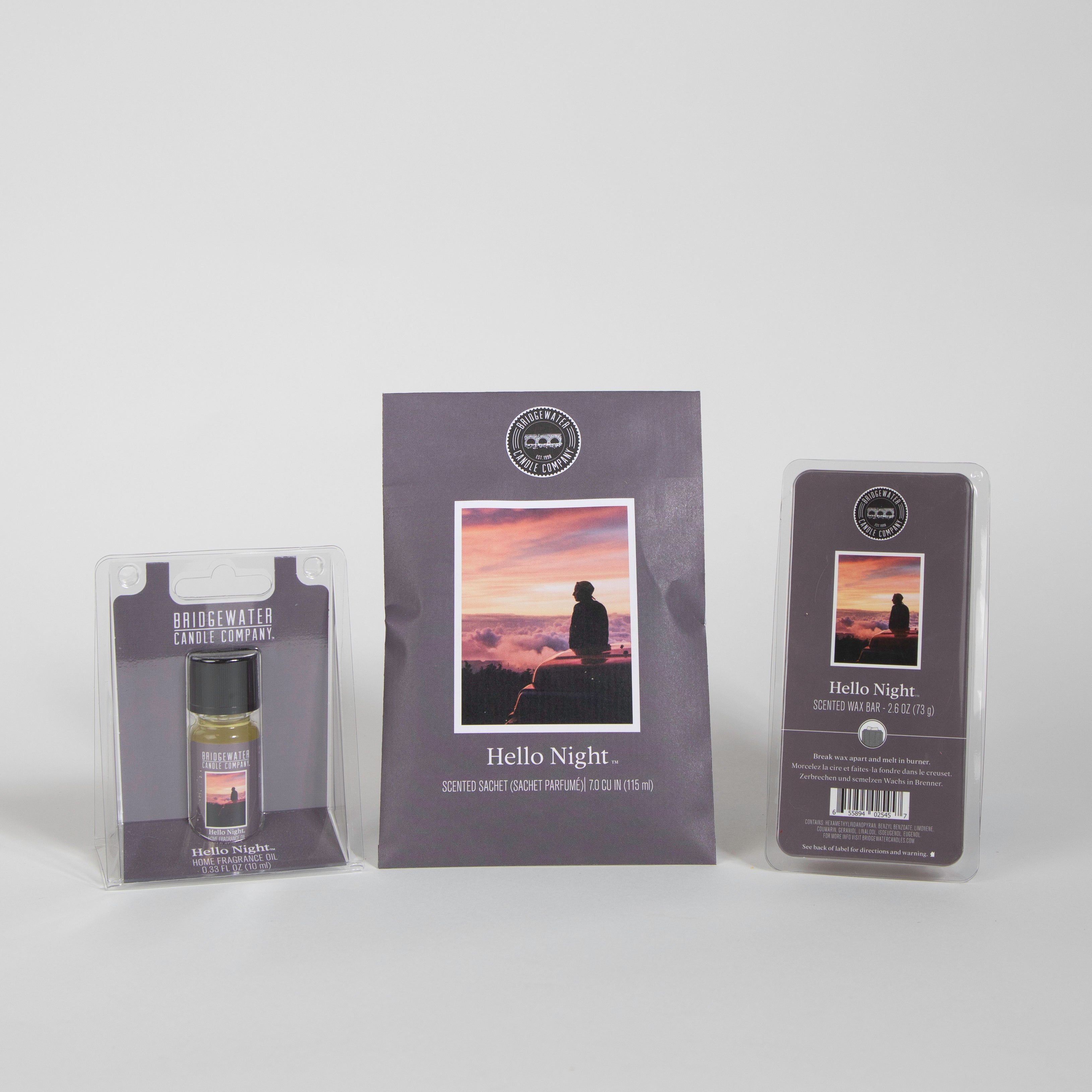 The Bridgewater Candle Company’s Hello Night - Flameless Bundle is displayed, featuring a scented sachet, home fragrance oil, and wax melts with packaging showing a person’s silhouette at sunset.