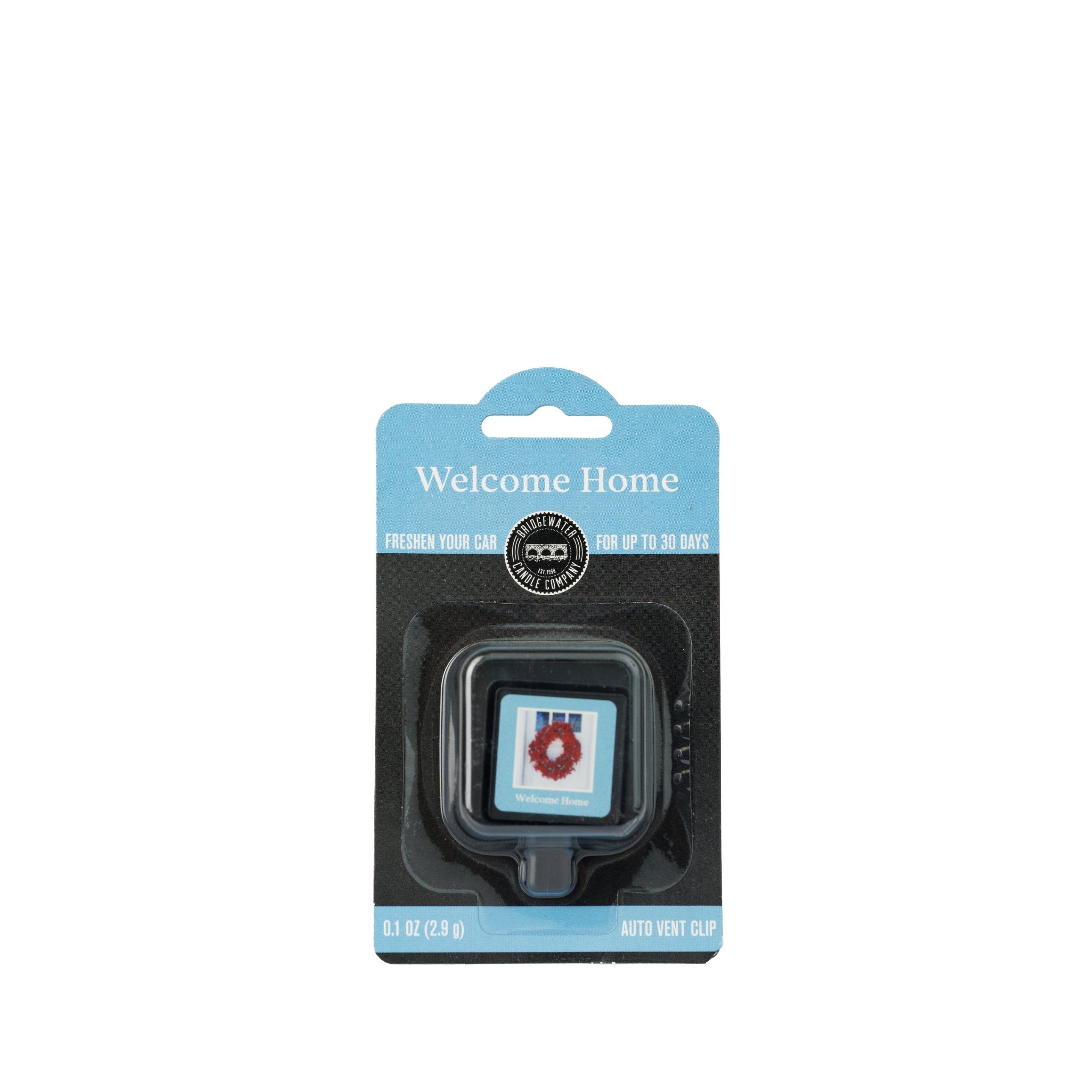 A Bridgewater Candle Auto Vent Clip-Welcome Home car air freshener in retail packaging featuring a square icon of a front door with a wreath.