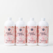 Four bottles from the Fast Bundle Back to School Laundry Bundle 4pk, each featuring pink and white circular patterned labels, are arranged in a row against a plain white background. This scented laundry detergent bundle brightens your fabrics while leaving your clothes with an irresistibly fresh scent after every wash.