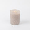 The Bridgewater Candle Sweet Grace Frosted Gray Candle rests on a plain white background—a perfect holiday gift that helps support the Light A Candle Feed A Child initiative.