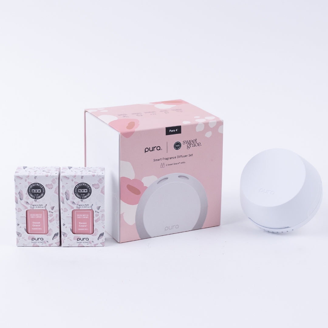 The Bridgewater Candle Company Pura + Bridgewater Sweet Grace Lovers Kit includes a white Pura Smart Home Diffuser and two Sweet Grace fragrance refills in pink and white boxes, all displayed on a light background.