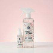 The Sweet Grace Stain Remover Bundle by Fast Bundle includes one large spray bottle and one small bottle, both with white labels featuring pink and beige circular designs, displayed against a pale pink background.