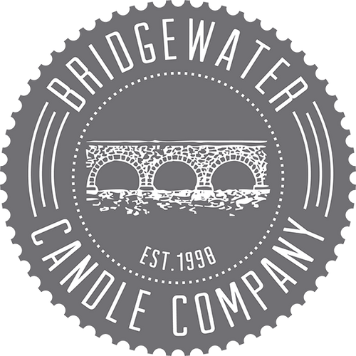 Gray circular logo with a white illustration of a stone bridge over water in the center. Text around the edge reads Bridgewater Candle Company and Est. 1998 below the bridge.