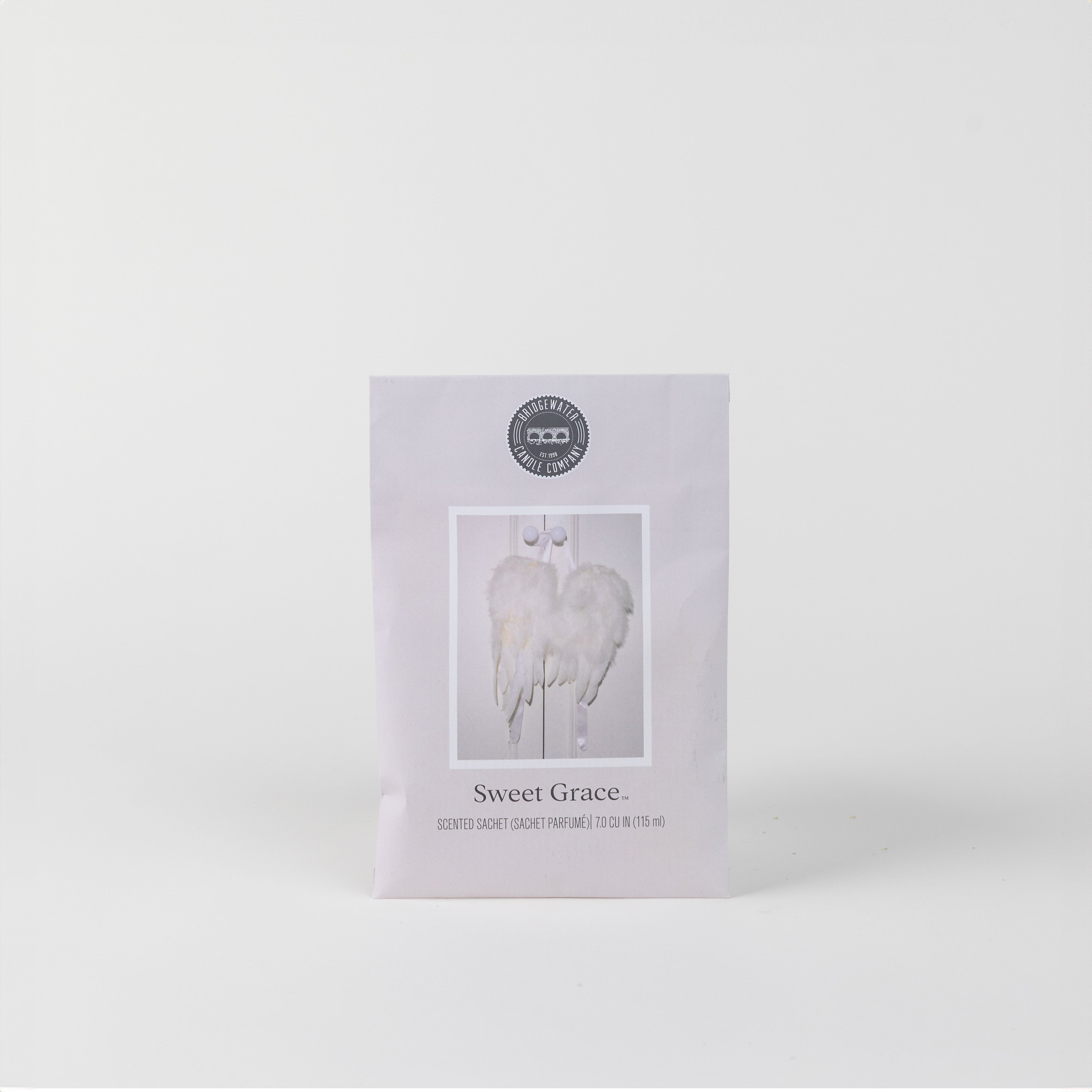 The Sweet Grace Sachet by Bridgewater Candle Company features soft white angel wings on a plain white background, making it the perfect home fragrance accent.