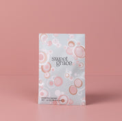 The Sweet Grace Modern Bubble Sachet by Bridgewater Candle Company features a pastel design with pink and white circles, standing upright against a pink background—an elegant addition to any home fragrance collection.