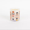 The Bridgewater Candle Sweet Grace Holiday Nutcracker Candle is a white soy-blend candle in a glass jar featuring colorful nutcracker illustrations, shown against a plain white background.