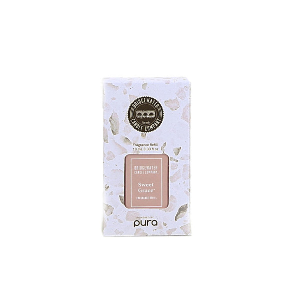 A white, speckled box of Bridgewater Candle Company Pura + Bridgewater Fragrance Refill - Sweet Grace, with a pale pink label and powered by Pura Smart Vials printed at the bottom.