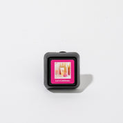 Bridgewater Candle Auto Vent Clip-Let’s Celebrate square car air freshener featuring a pink frame around an image of a champagne glass and the text Lets Celebrate.