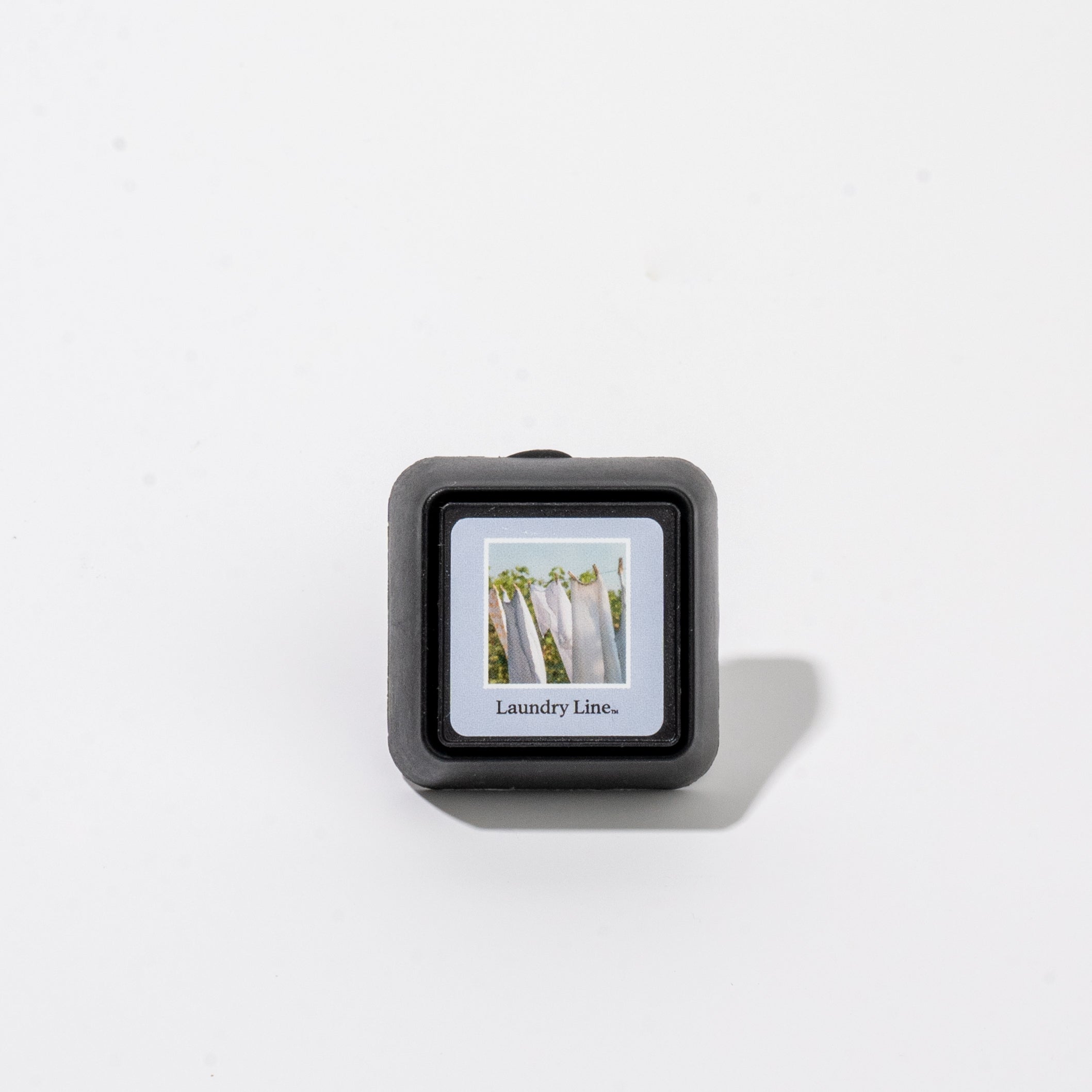 Square Bridgewater Auto Vent Clip-Laundry Line fragrance car air freshener featuring an image of clothes hanging on a line with the text Laundry Line.