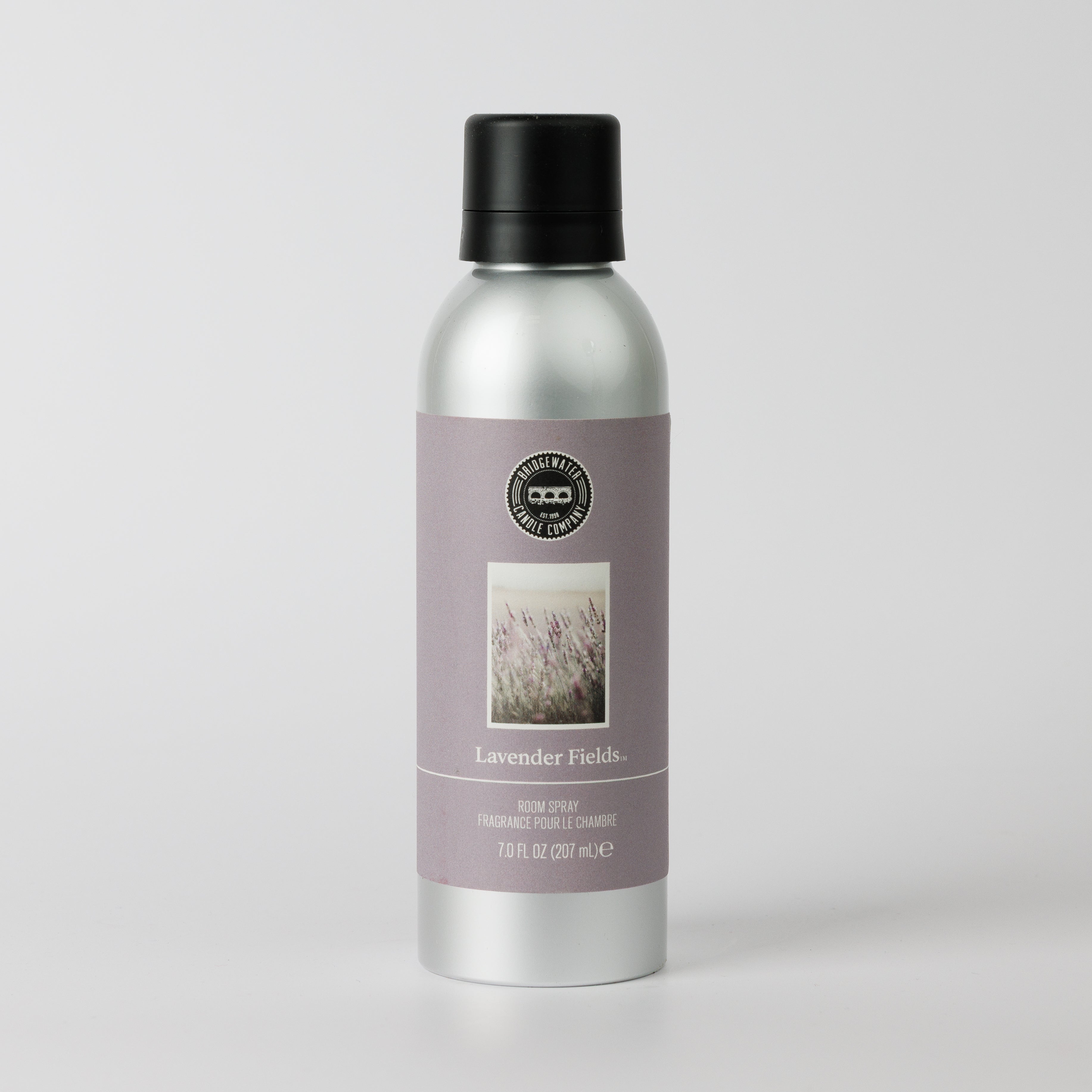 The Bridgewater Candle Lavender Fields Non-Aerosol Room Spray features a calming lavender scent in a silver bottle with a black cap and lavender label—perfect for refreshing any space.