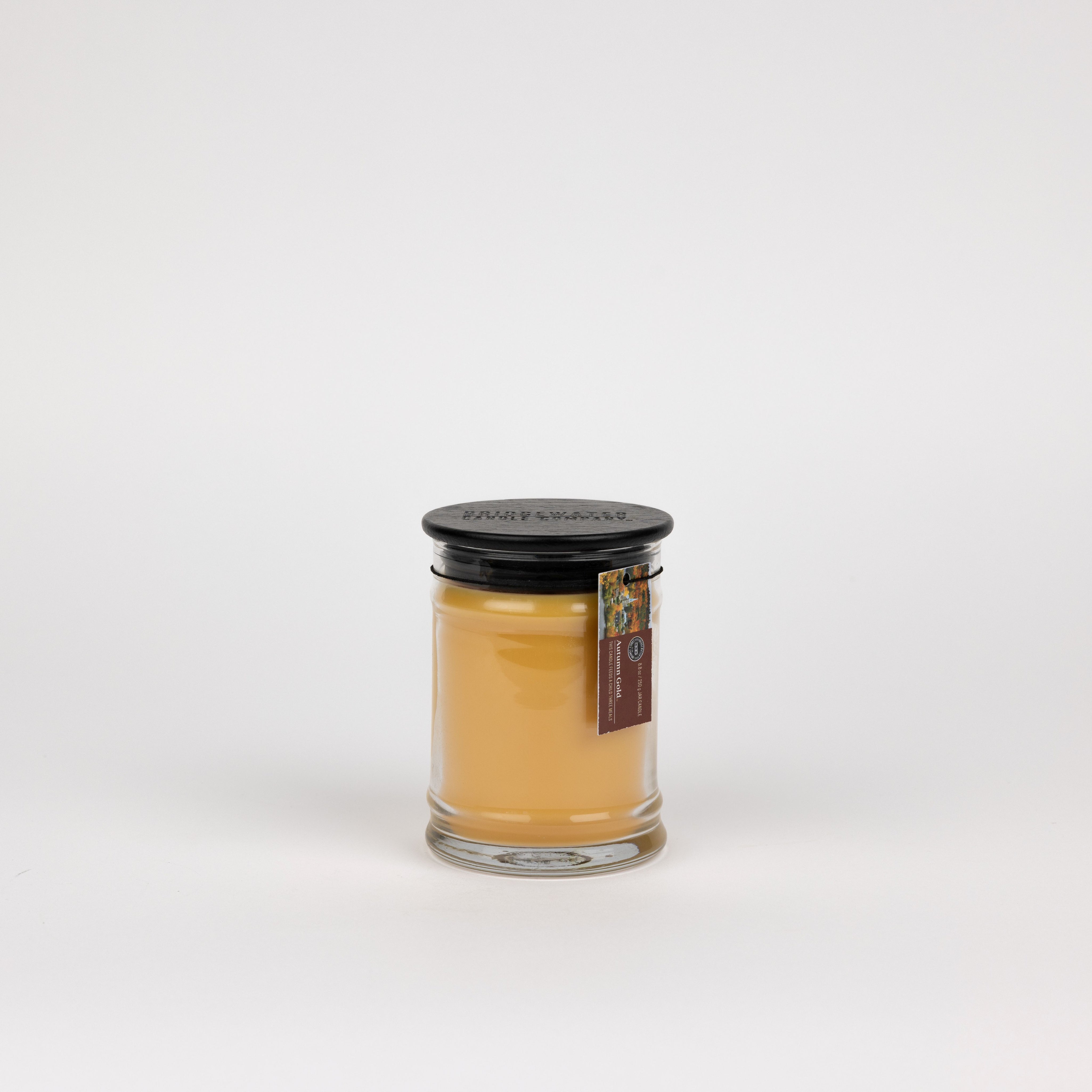The Bridgewater Candle Autumn Gold Small Jar Candle features soy-blend wax, a black lid, and brown label, all set against a plain white background.