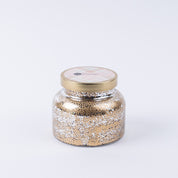 The Bridgewater Candle Company Sweet Grace Mercury Jar Candle features gold and silver speckles, a round gold lid, and soy-blend wax, shown against a plain white background.