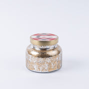 The Bridgewater Candle Company Comfort & Joy Holiday Mercury Jar Candle features premium soy-blend wax in a decorative glass jar with gold and white speckles, a gold lid with pink and gray plaid, and a small label—all set against a white background.