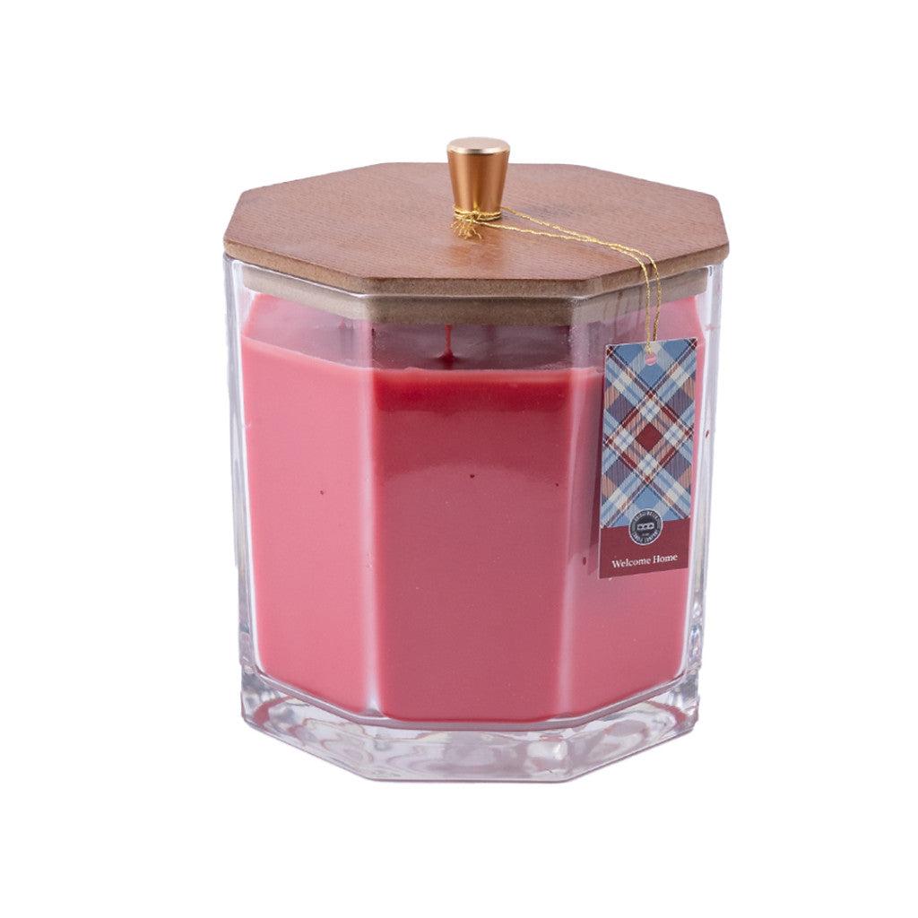 The Welcome Home Large Decorative Candle by Bridgewater Candle Company features a pink faceted glass jar, wooden hexagonal lid with gold knob, plaid tag, and premium soy-blend wax—perfect as stylish home decor with a clean burn.