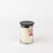 A Bridgewater Candle Company Lets Celebrate 8oz Jar Candle with a black lid and a label featuring a drink and LIGHT A CANDLE FEED A CHILD, displayed against a plain white background.