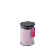 The Bridgewater Candle Company XOXO 8oz Small Jar Candle features light pink soy-blend wax, a dark lid, a colorful tag on top, and is infused with Bridgewater’s signature fragrance.