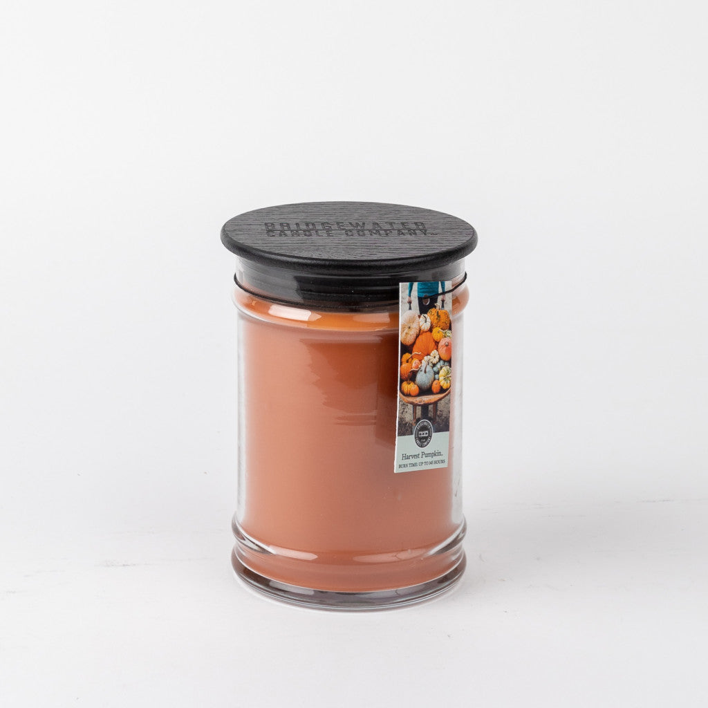Bridgewater Candle Companys Harvest Pumpkin 18oz Large Jar Candle features orange-brown wax, a black lid, and a pumpkin-themed label reading Baked Pumpkin, displayed on a white background.