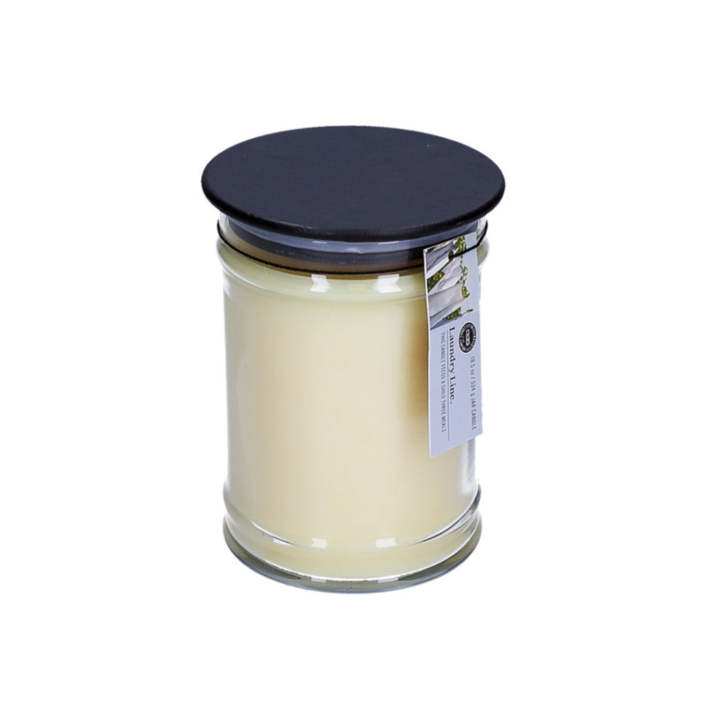 The Bridgewater Candle Company Laundry Line 18oz Large Jar Candle features cream-colored soy-blend wax, a black lid with twine-attached tag, and is displayed on a plain white background.