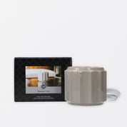A grey, ribbed Wax Warmer-Grey Banded by Bridgewater Candle Company sits beside its box, which displays the warmer and product name. A clear power cord extends from the warmer, perfect for melting wax melts or fragrance oils.