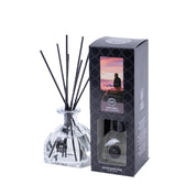 A clear glass Hello Night Reed Diffuser by Bridgewater Candle Company with black fiber reeds sits beside its black box, which has a window and a sunset viewing image—a premium fragrance touch for any space.