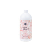 A white plastic bottle of Bridgewater Candle Companys Sweet Grace 32oz Laundry Detergent features a pink label with bubble designs, offering a luxurious formula and long-lasting scent.