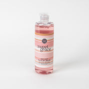 A clear bottle of Bridgewater Candle Company Sweet Grace Dish Soap with a white cap and a label featuring pastel pink and white stripes. The best-selling fragrance is highlighted, and the product is displayed on a plain white background.