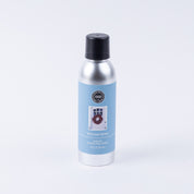 The Bridgewater Candle Company Welcome Home Non-Aerosol Room Spray features a silver can with a black cap and blue label with a door and wreath image. The eco-friendly spray stands upright against a plain white background.