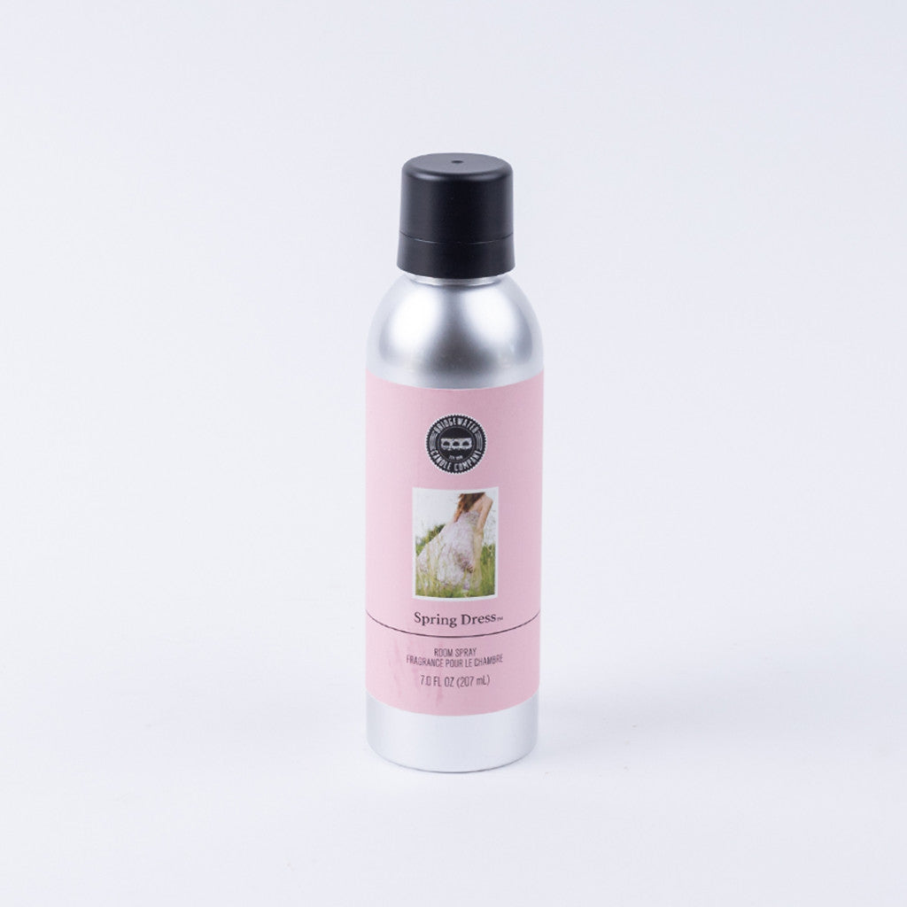 A silver can with a black cap and pink label reading Spring Dress by Bridgewater Candle Company. Featuring a dress image, this eco-friendly, premium non-aerosol room spray is shown on a plain white background.
