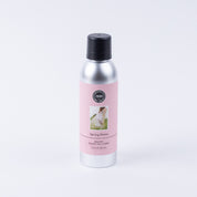 A silver can with a black cap and pink label reading Spring Dress by Bridgewater Candle Company. Featuring a dress image, this eco-friendly, premium non-aerosol room spray is shown on a plain white background.