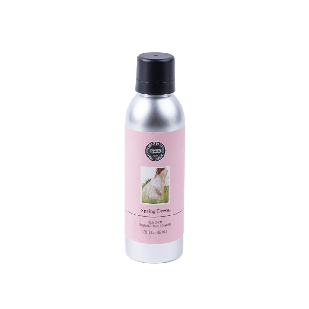 A silver non-aerosol spray can with a black cap and pink Spring Dress label featuring a dress image—Bridgewater Candle Company’s eco-friendly room spray is a premium home fragrance for any room.