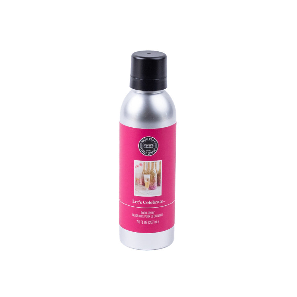 A silver can with a black cap and pink label reading Lets Celebrate Non-Aerosol Room Spray by Bridgewater Candle Company, featuring champagne glasses and festive décor—perfect for creating a joyful, eco-friendly home fragrance.