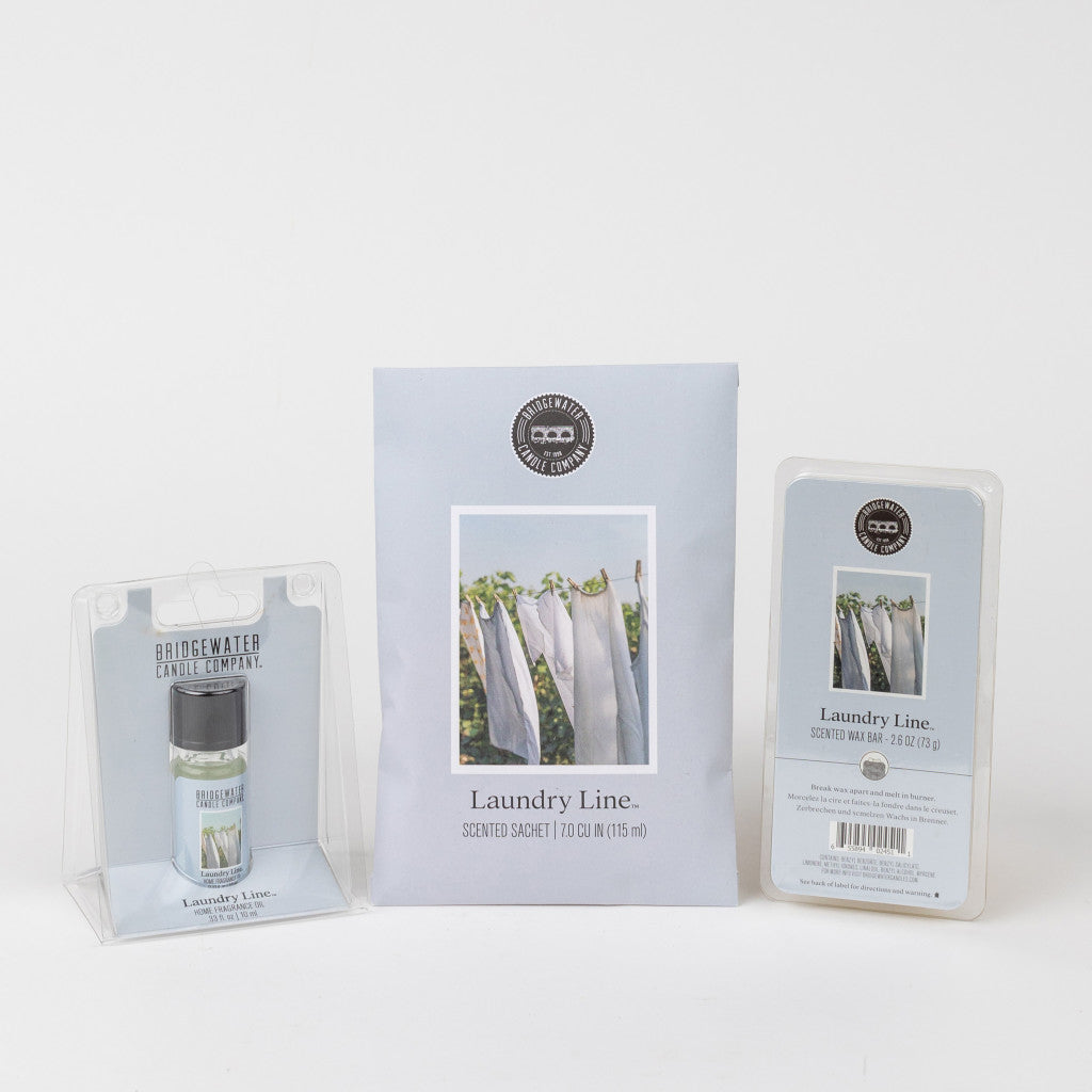The Bridgewater Candle Company Laundry Line Flameless Bundle is displayed against a white background, with each item in light blue packaging featuring an image of laundry drying on a clothesline.