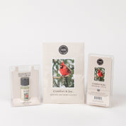 The Bridgewater Candle Company Comfort & Joy Flameless Bundle includes a scented sachet with a cardinal design, home fragrance oil in clear packaging, and scented wax bars in a plastic container.