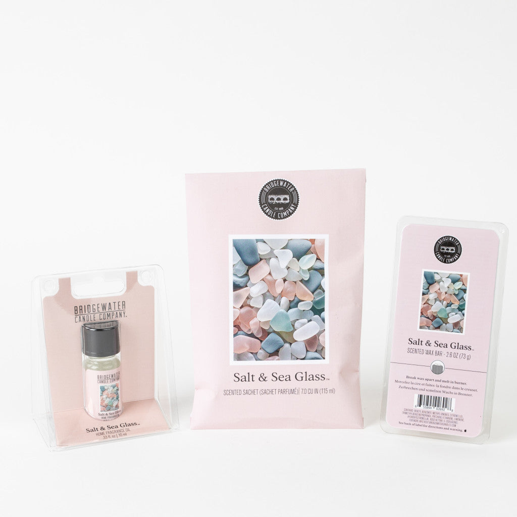 The Salt & Sea Glass Flameless Bundle by Bridgewater Candle Company features a scented sachet, small jar candle, and wax bar in pastel sea glass-inspired packaging with minimalist pink and white designs—an ideal flameless gift set.