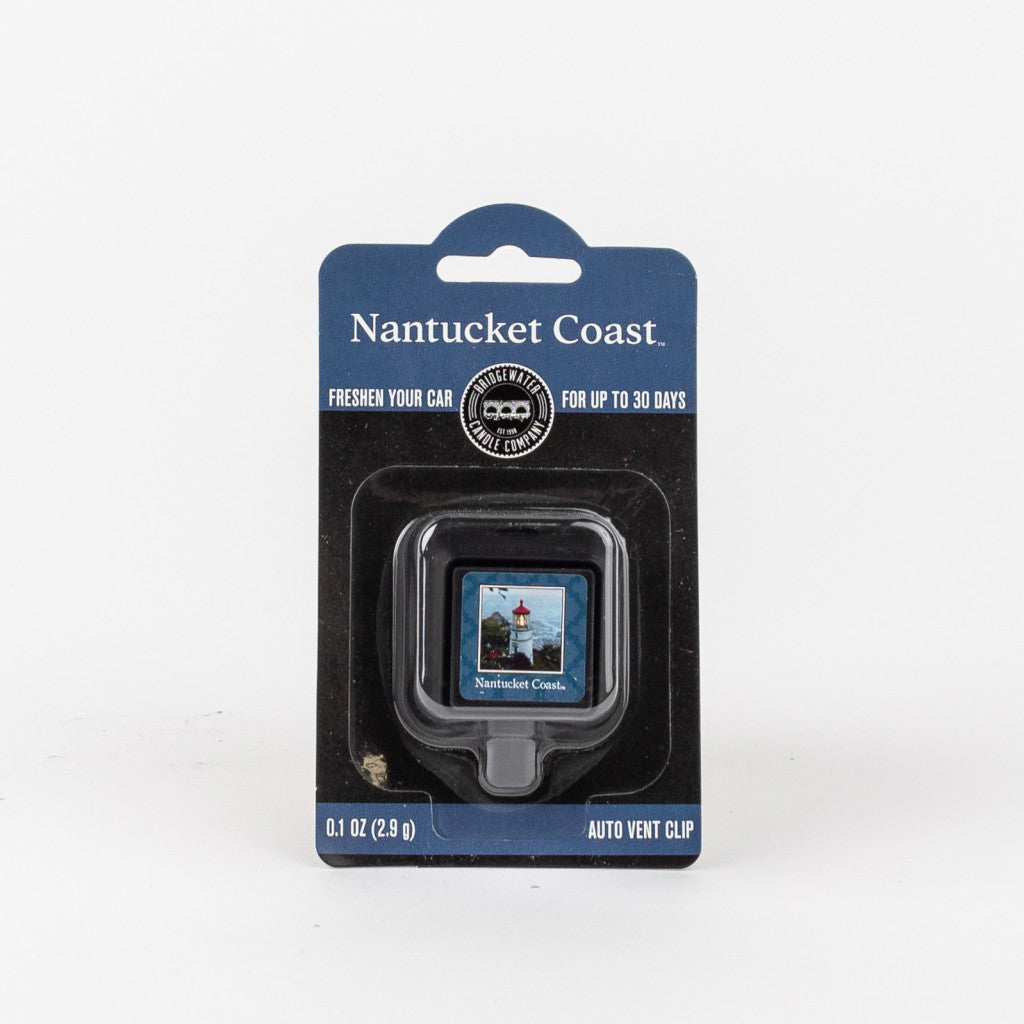 A Bridgewater Candle Company Nantucket Coast Auto Vent Clip car air freshener in black packaging, featuring a seaside lighthouse image and stating it lasts up to 30 days.