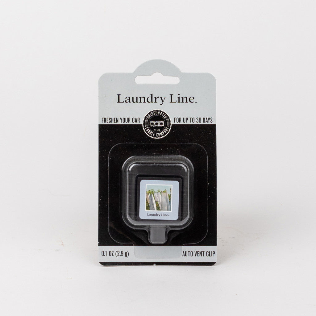 The Bridgewater Candle Company Laundry Line Auto Vent Clip car air freshener features a laundry line scent, lasts up to 30 days, and its packaging shows clothes hanging on a clothesline.