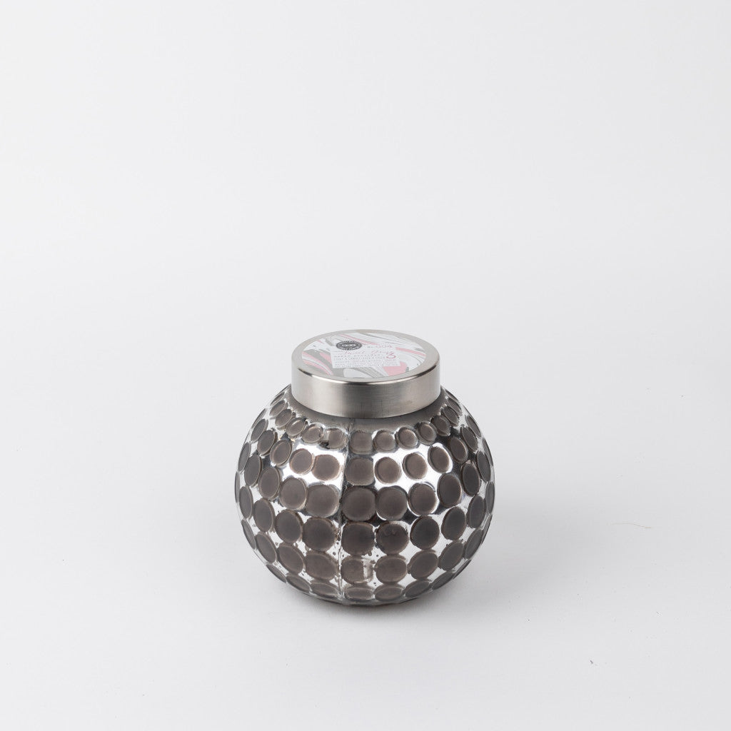 A round, silver metallic candle jar with a dimpled, polka-dot pattern and a flat, silver lid, set against a plain white background.
