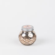 The Sweet Grace Collection Candle #008 by Bridgewater Candle Company features a round, metallic gold jar with a silver lid and pink label, crafted from soy-blend wax and shown against a plain white background.