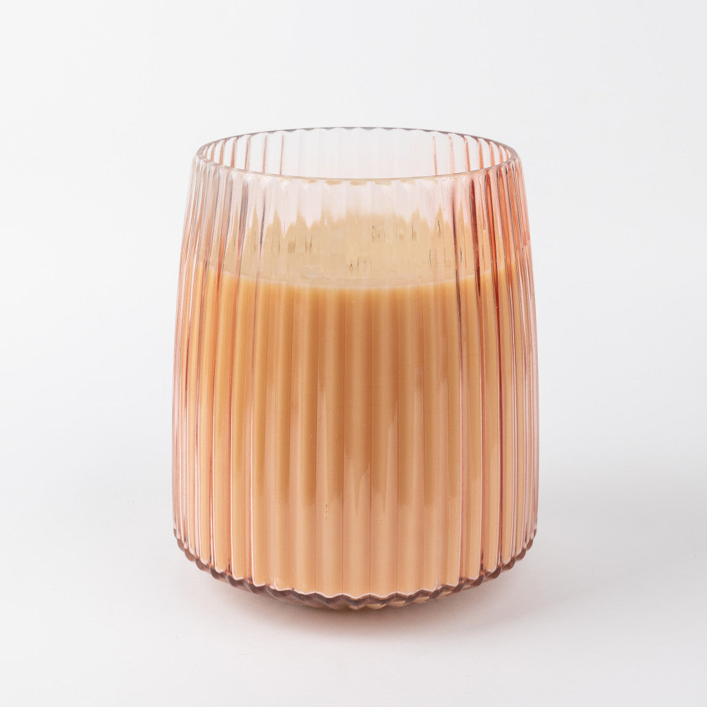 A light brown chai tea in a ribbed tumbler sits on a white background, evoking the soft glow of the Sweet Grace Collection Candle #043 by Bridgewater Candle Company with its five cotton wicks.