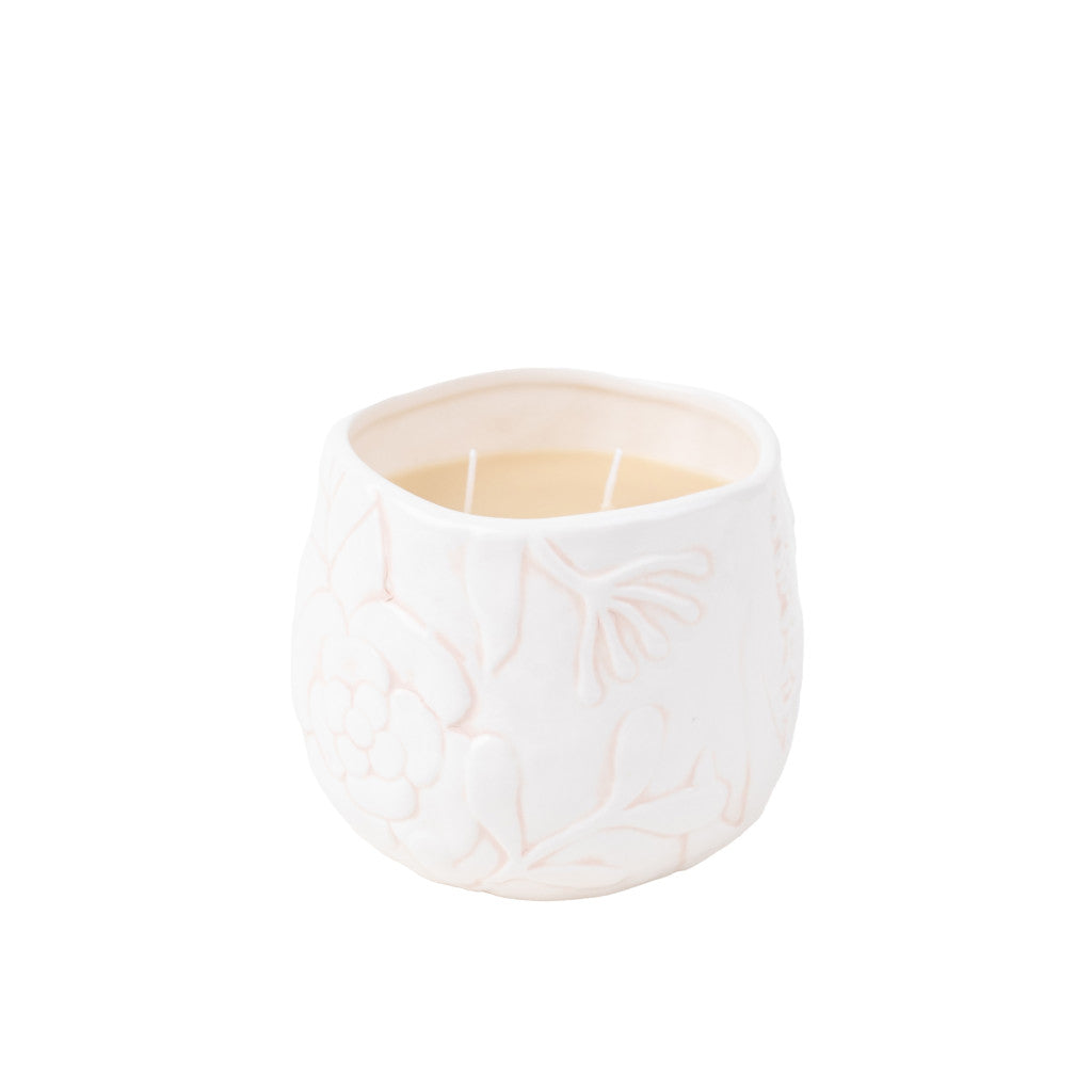 The Bridgewater Candle Company’s Sweet Grace Collection Candle #057 sits in a white ceramic holder with a floral pattern, crafted from soy-blend wax and two wicks, adding luxurious fragrance against a plain white background.