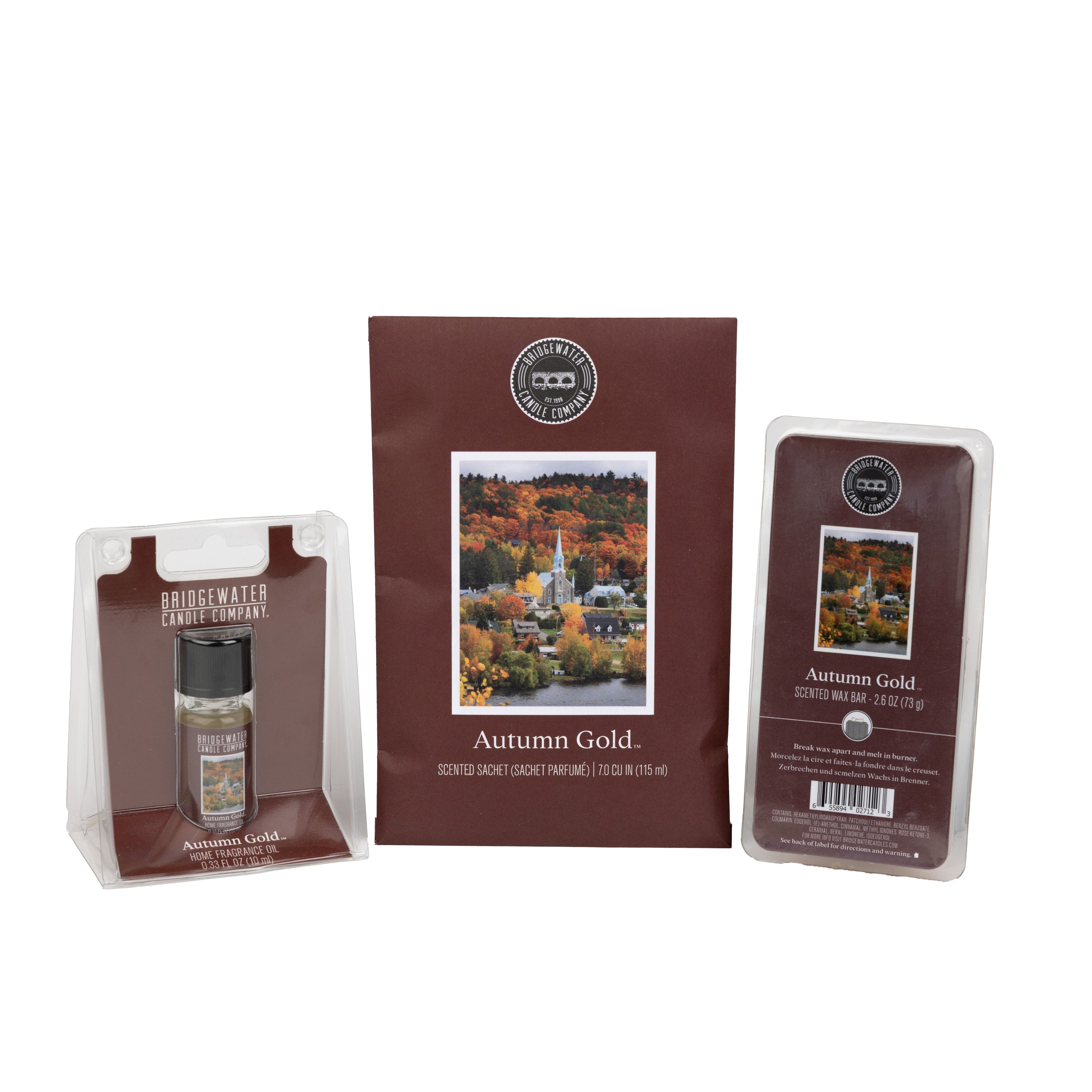 The Bridgewater Candle Autumn Gold Flameless Bundle includes a small room spray, fall foliage sachet, and soy-blend wax bar in brown packaging with autumn-themed labels, creating a cozy seasonal fragrance experience.