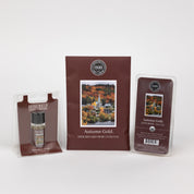 The Bridgewater Candle Autumn Gold Flameless Bundle includes a small jar candle, scented sachet, and soy-blend wax bar, each in brown packaging with autumn town imagery for a cozy fall atmosphere.
