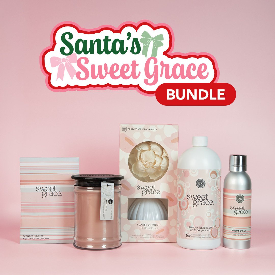 A display of Fast Bundle’s Santa's Sweet Grace Bundle, featuring a candle, flower diffuser, room spray, scented sachet, and laundry detergent, beautifully arranged against a pink background.